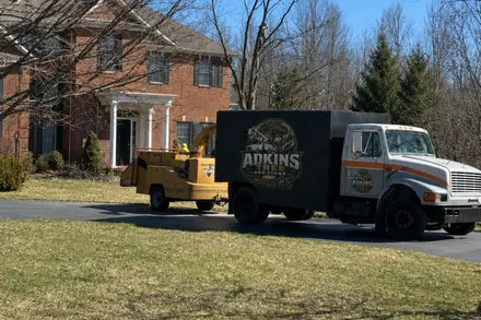 The Adkins truck and chipper loaded up on a driveway at the end of a job.